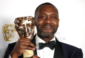 An image of Lenny Henry holding an award